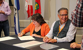 From left: NNEC Executive Director Norma Kejick and Lac Seul First Nation Chief Clifford Bull sign a Memorandum of Understanding along with SLFNHA.   Photo courtesy of Lac Seul First Nation