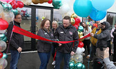 Your Dollar Store With More Managers Derek Nadon (centre, right) and Maura Ross (centre, left) cut a grand opening ribbon to officially open the new store.   Tim Brody / Bulletin Photo