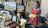 Teresa Bowyer (left) showcases her artwork, while Makayla Hoftyzer (right) serves up crepes she prepared through her business Christmas Delights.   Tim Brody / Bulletin Photo