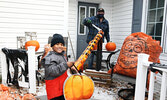 Joe Carbone and his grandson Theo Carbone test out the candy chute Carbone installed at his Queen Street residence to safely share treats with visiting trick or treaters on Halloween night. - Tim Brody / Bulletin Photo