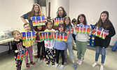 Local artist Gabrielle Wesley (standing back row, left) poses with participants in the kid’s art class she instructed on March 3 at the Rec Centre during this year’s Winter Festival. Children were excited to show off their works of art.   Tim Brody / Bull