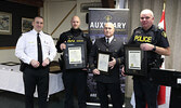 From left: OPP North West Region Chief Superintendent/Regional Commander Bryan MacKillop presents the Commissioner’s Citation for Bravery to Provincial Constable Curtis Robb, Sioux Lookout Fire Captain Greg Olson, and Sergeant Kevin Young.   Tim Brody / B