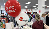 After waiting for the doors to the Red Apple store to open, customers explored the store’s selection of products as they shopped. A ribbon-cutting ceremony preceded the opening of the store.     Tim Brody / Bulletin Photo