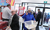 The first customers to the newly re-opened Red Apple store in Sioux Lookout are welcomed as they make their way through the doors. The first 100 customers received a $10 gift card and laundry basket as a special gift.     Tim Brody / Bulletin Photo
