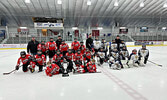 The Sioux Wolverines (left, in red) and Sioux Storm pose for a group photo after their championship game.   Submitted Photo