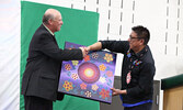 Mercer (left) accepts a gift for the school from NAN Grand Chief Alvin Fiddler. - Tim Brody / Bulletin Photo