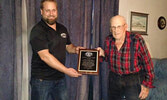 Ontario Fur Managers Federation representative Erik Treftlin (left) presents Adam Zarecki with the organization’s Lifetime Achievement Award. - Zarecki Family / Submitted Photos