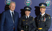 Constable Andrea Degagne (centre) receives the OACP Award of Excellence in Community Safety, Wellness and Crime Prevention from Accident Support Services International Ltd. President Steve Sanderson (left) and OPP Commissioner Thomas Carrique (right).   P
