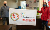 Sioux Lookout Mayor Doug Lawrance (left) was joined by Andrea Dick from FIREFLY to raise the autism awareness flag at the Sioux Lookout Municipal Office.    Chris Pollard / Submitted Photo