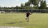 Wyatt McKay running for a fly ball in left field.   Angela Anderson / Bulletin Photo