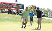 Kyle Briska (right) congratulates Greg Olsen (left) on a perfect putt, while John Carnochan (centre) looks on. - Tim Brody / Bulletin Photo