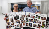 Susan and Bill Hochstedler with photos of their grandson Kaleb and his family as Kaleb undergoes cancer treatments. - Tim Brody / Bulletin Photo