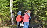 Joanne Ford (right) searches for birds along the treetops at Cedar Bay. - Jesse Bonello / Bulletin Photo