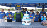 Pictured: Members of the Blueberry Festival Committee surprised Blueberry Festival mascot Blueberry Bert with a special cake for his 38th birthday and invited parents to drive by the empty lot on Wellington Street with their children during the 2020 Blueb