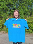 Blueberry Festival Coordinator Jessica Darling displays this year’s Blueberry Festival t-shirt, which features the new logo for this year’s festival. T-shirt sales will be the primary fundraising method for the Blueberry Festival Committee as they look to