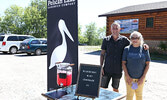 Pelican Lake Sandwich Company owner Andrew Jones (left) and his mother Yvette Jones serve Blueberry Mint Lemonade as part of the drive-through Blueberry Festival Opening Ceremonies.  - Tim Brody / Bulletin Photos