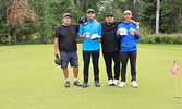 Bombers Golf Classic second-place winners holding their prizes From left: Gene Duncan, Ryan Raspado, Titus Morris, and Ronan Raspado. 