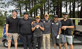 From left: New signing Hudson Gagne, GM Austen Hoey, Assistant Coach Chris “Scoot” Johnstone, Head Coach Carson Johnstone, Forward Owen Cotter, and Goalie Coach Jason Murphy pose for a photo during this year’s tournament.     Photo courtesy Sioux Lookout 