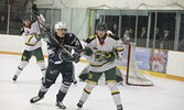 Bombers and Ice Dogs players keep an eye on the play.   Tim Brody / Bulletin Photo