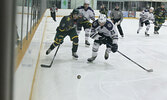 Conner Burke of the Sioux Lookout Bombers (left) and Easton Debray of the Dryden GM Ice Dogs race for the puck.   Tim Brody / Bulletin Photo