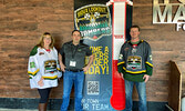 From left: Bombers Treasurer Christine Hoey, Fresh Market Foods Owner Todd Nadon, and Bombers Director of Game Day Operations Matt Cairns pose for a photo alongside a fundraising thermometer for the team, which will stay at Fresh Market Foods, showing the