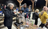 Friends of Cedar Bay board member Joyce Timpson serves hot chocolate to Boo At The Bay visitors.   Tim Brody / Bulletin Photo
