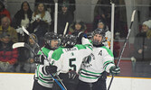 Isaiah Lawson (5), Ben Forbes (right) and other Warriors celebrate after one of their five goals during game two of the NorWOSSA finals against the Fort Frances Muskies. - Jesse Bonello / Bulletin Photo