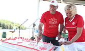 Sioux Lookout Mayor Doug Lawrance and his wife Cherry Lawrance serve a Canada Day cake prepared by Sioux Lookout resident Althea George. - Tim Brody / Bulletin Photo