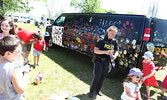 OPP constable Andrea DeGagne opens more paint for Canada Day visitors to decorate an OPP vehicle with. - Tim Brody / Bulletin Photos