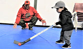 Ranger Freeman Ningewance plays with Pikangikum evacuee Manny Turtle at Pelican Falls First Nations High School. - Sergent Peter Moon / Submitted Photo