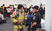 Sioux Lookout Fire Chief Rob Favot (right) helped students gear up in firefighting equipment during the career fair. - Jesse Bonello / Bulletin Photo
