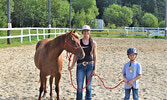 Merrick Tibbs-Burnard (right) met Cedar Bay Stables’ newest addition Nala (pictured) during a free pony ride on July 23. Merrick was joined by Cedar Bay co-chair Destiny Pryzner (middle). - Jesse Bonello / Bulletin Photo