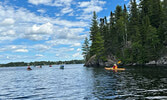 Event participants paddle around Equay-Minis Island.   Photo courtesy of Darlene Angeconeb