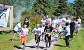 Runners charge through starting line ribbons while getting showered with colour at the Sioux Lookout Travel Information Centre. - Jesse Bonello / Bulletin Photo