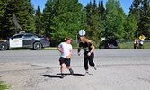 Sioux Lookout OPP Constable Andrea DeGagne (right) cheered on and motivated participants, just outside of the MNR Fire Management Headquarters, as they ran. - Jesse Bonello / Bulletin Photos
