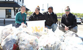From left: NWHU Public Health Nurse Emily Monaco, Elevate NWO Community Support Worker Jasmine Savage, , Elevate NWO Community Support Worker Shawn Necanapence, and NWHU Public Health Nurse Jessica Thompson with garbage and needles collected.   Tim Brody 