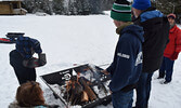 Guests and passersby enjoyed roasting hot dogs over a crackling fire outside of the Cosy Cabin. - Jesse Bonello / Bulletin Photo