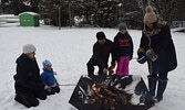 Guests and passersby enjoyed roasting hot dogs over a crackling fire outside of the Cosy Cabin. - Jesse Bonello / Bulletin Photo