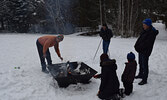 Guests and passersby enjoyed roasting hot dogs over a crackling fire outside of the Cosy Cabin. - Jesse Bonello / Bulletin Photo