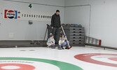 Jon Salo teaches his children the sport of curling.   Tim Brody / Bulletin Photo