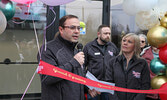 Your Dollar Store With More co-owner Todd Nadon (foreground with microphone) welcomes people to the store’s grand opening and thanked everyone who contributed to the store becoming a reality.   Tim Brody / Bulletin Photo