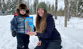 Colt Sanderson, along with his mother Danielle Lillie, display the chocolate bunny they found while visiting Cedar Bay on April 16.   Tim Brody / Bulletin Photo