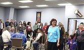 Elders and conference delegates dance with students from Obishikokaang Elementary School, while drummers perform an honour song for the children. - Tim Brody / Bulletin Photo