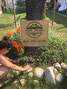 Jackie Bernier working on some gardening around Rock Front Family Farm’s lawn sign in their front yard.      Rock Front Family Farm / Submitted Photo