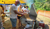 Members of the Sioux Lookout Lions Club, from left, Chris Larsh, Pat Hildebrand, and Sheryl Melnichuk prepare meals to be served for their drive-thru barbecue event.      Reeti Meenakshi Rohilla / Bulletin Photo