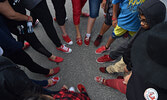 Supporters of Red Shoe Rock standing in a circle, wearing red shoes.  - Bulletin File Photo