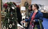 Visitors to the annual Christmas Arts and Craft Fair browse the wide variety of wares for sale by local bakers and artisans.   Tim Brody / Bulletin Photo