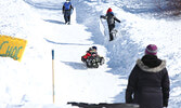 Many children laughed with delight or yelled with joy as they raced down the sliding hill. - Tim Brody / Bulletin Photo