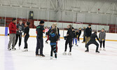 Kurt Browning (fourth from left) mingles with skating seminar participants and members of the community at a public skate held last Saturday night.   Tim Brody / Bulletin Photo