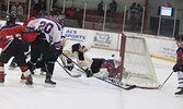 Local police officers and local firefighters in action in last Saturday’s charity hockey game.     Tim Brody / Bulletin Photo
